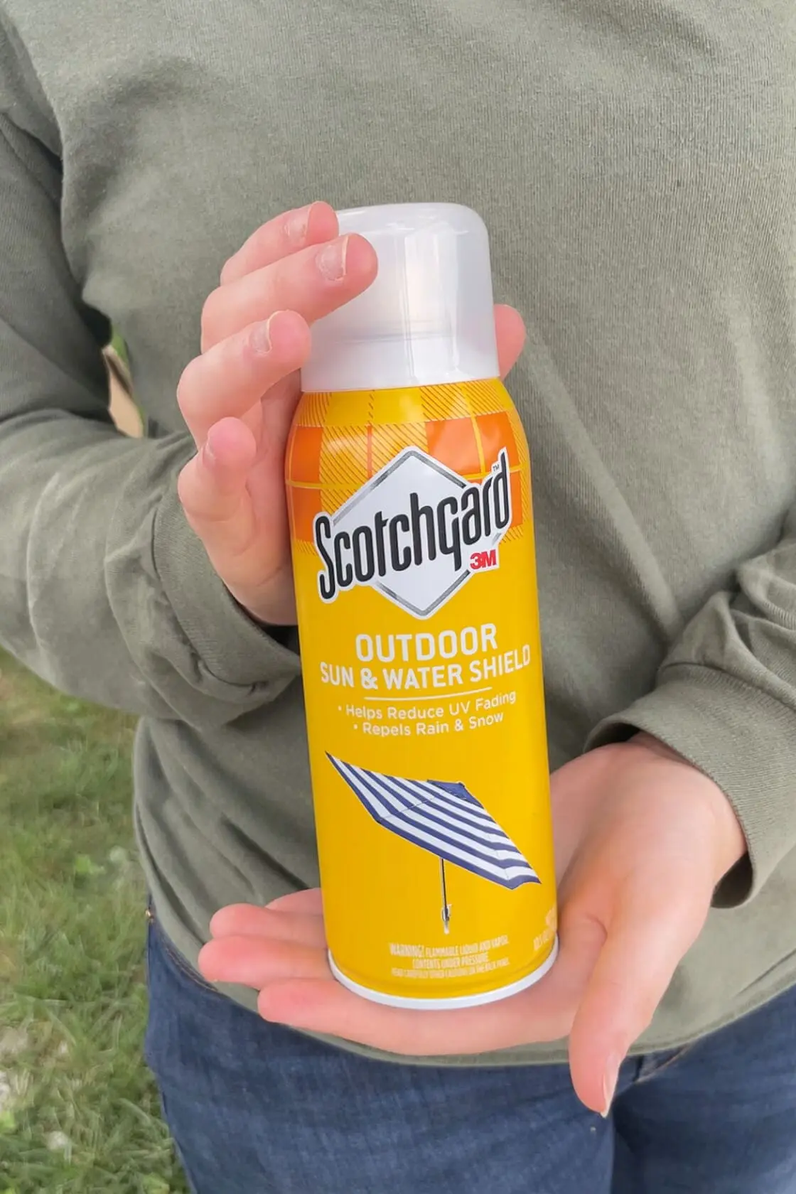 Treating a backyard hammock with Scotchguard.